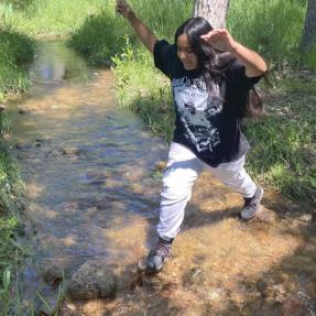 Girl crossing the stream at Primos Park